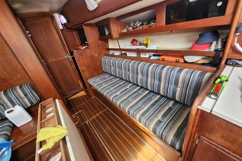 Slide: The Image of Interior of 1981 Columbia Yacht 10.7 with striped seating and wooden cabinetry. - 5