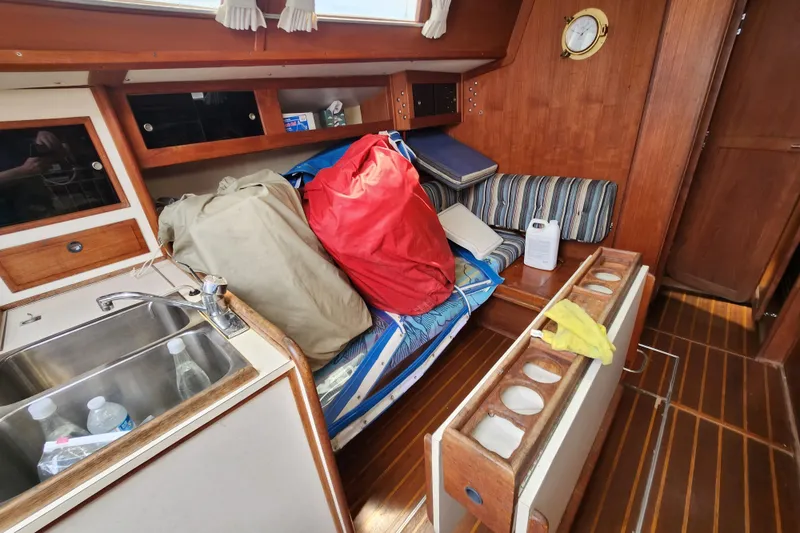 Slide: The Image of Interior of 1981 Columbia Yacht 10.7 with storage and seating area. - 6
