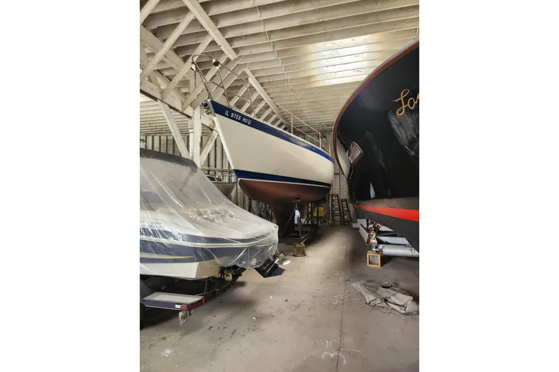 Slide: The Image of 1978 Columbia Yacht 10.7 stored indoors alongside other boats. - 7