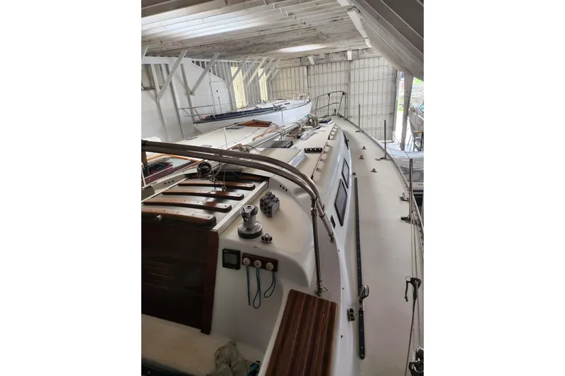 Slide: The Image of 1978 Columbia Yacht 10.7 in a boathouse, showcasing deck and cabin details. - 8