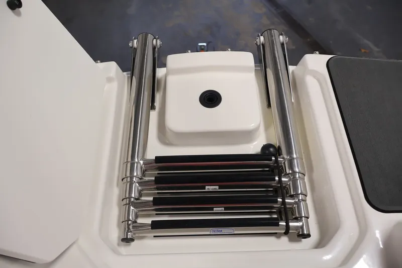 Slide: The Image of 2026 Bayliner D22I boat ladder, stainless steel, folded on deck. - 11