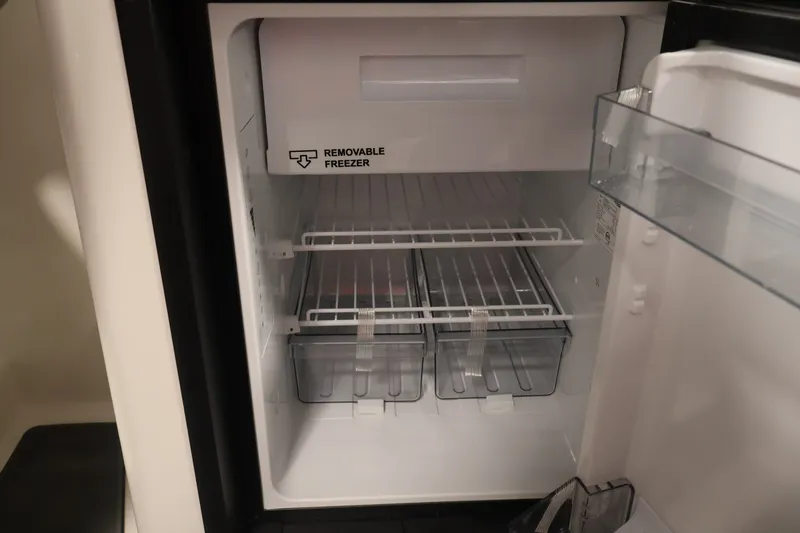 Slide: The Image of Interior of a Bayliner D22I 2026 boat fridge with removable freezer compartment. - 30