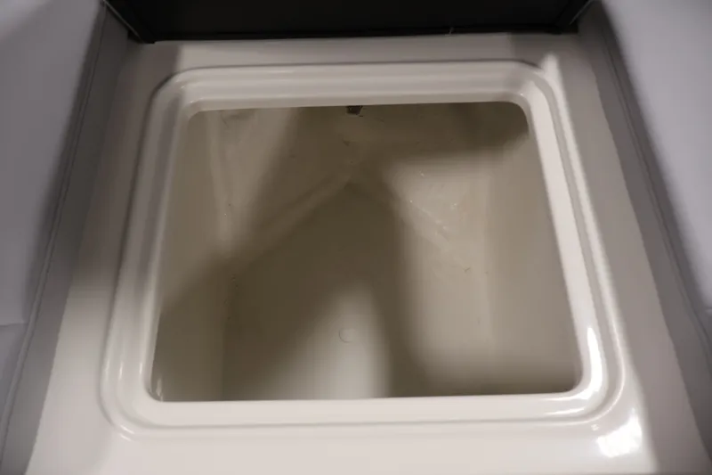 Slide: The Image of Storage compartment of 2026 Bayliner D22I boat, featuring a clean, white interior. - 13