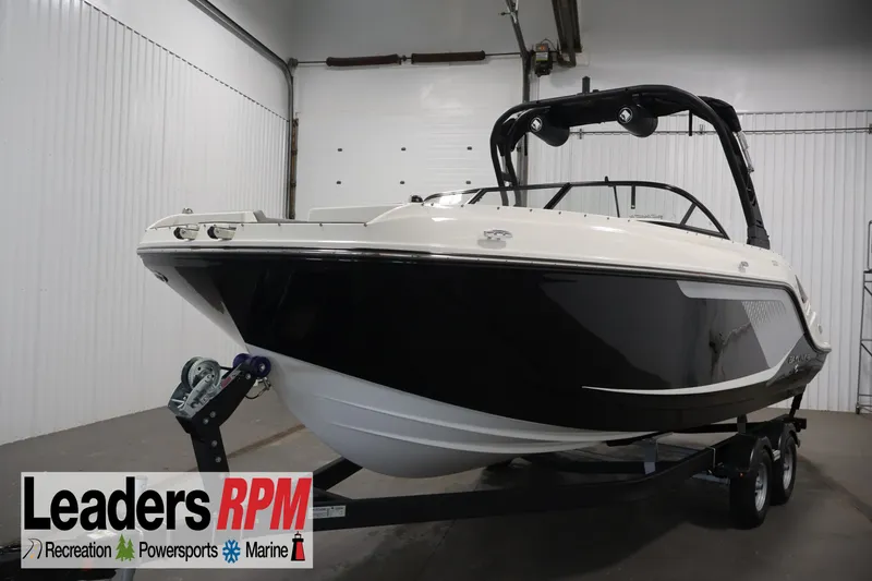 The Image of 2026 Bayliner D22I boat on trailer in showroom, Leaders RPM branding visible. - 0
