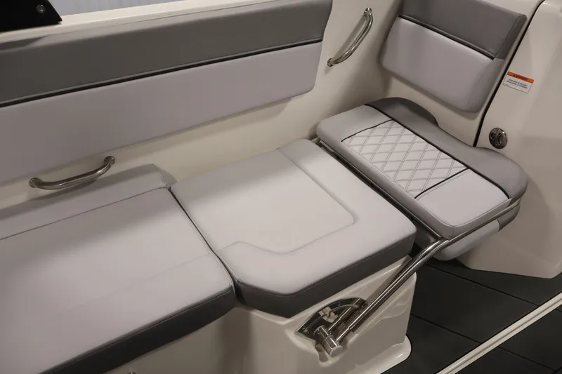 Slide: The Image of 2026 Bayliner D22I boat interior with sleek, cushioned seating and stainless steel handles. - 28