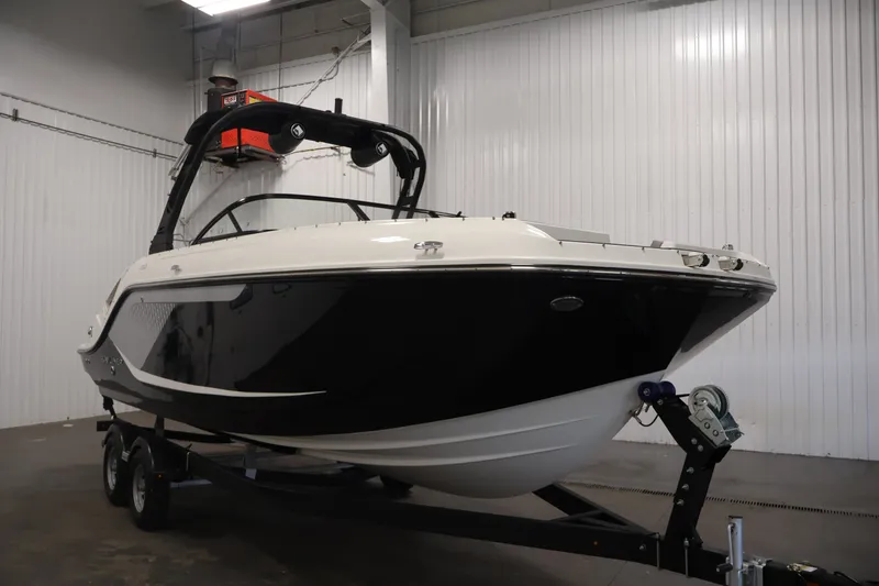 Slide: The Image of 2026 Bayliner D22I boat on trailer in indoor storage facility. - 2