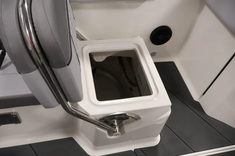 Slide: The Image of 2026 Bayliner D22I boat interior with open storage compartment and cushioned seating. - 27