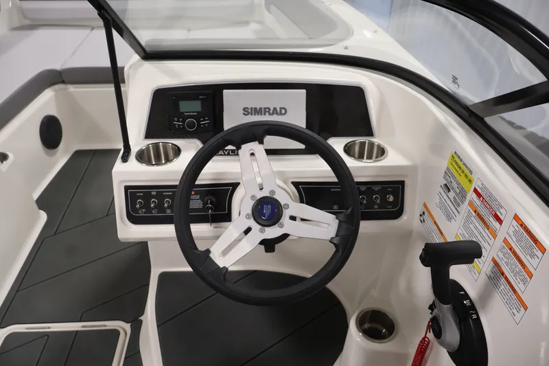 Slide: The Image of Steering console of 2026 Bayliner D22I boat with Simrad display and controls. - 16