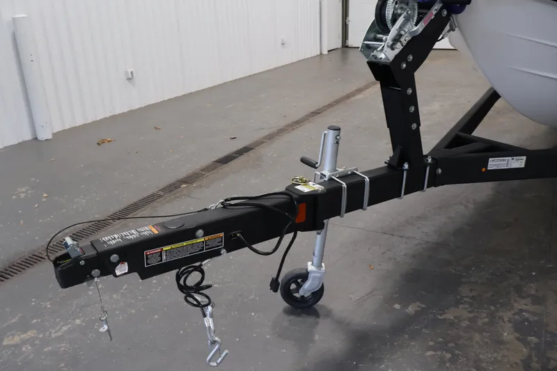 Slide: The Image of Trailer hitch of a 2026 Bayliner D22I boat in a garage setting. - 44