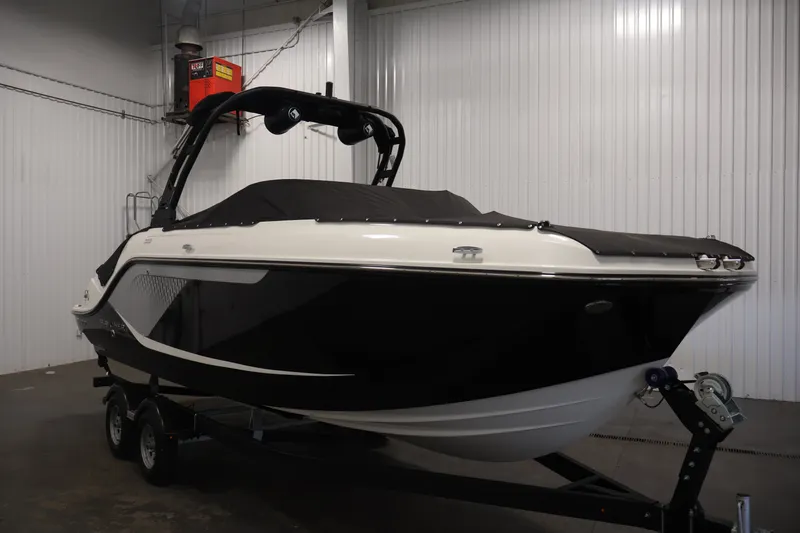 Slide: The Image of 2026 Bayliner D22I boat in a showroom, black and white design, on a trailer. - 47