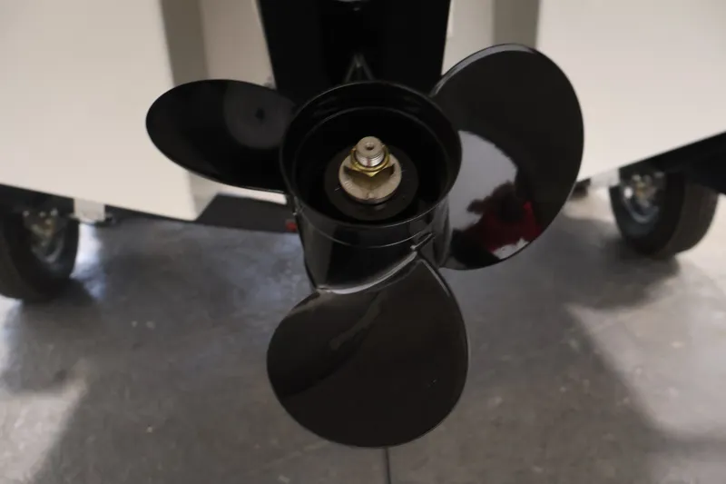 Slide: The Image of Close-up of a 2026 Bayliner D22I boat propeller, showcasing its sleek black blades. - 43