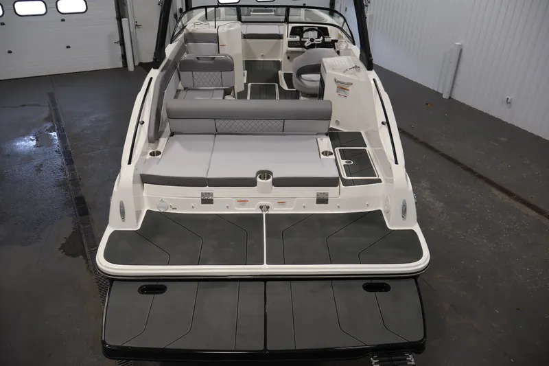 Slide: The Image of 2026 Bayliner D22I boat interior with gray seating and modern design in a showroom. - 9