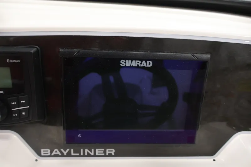 Slide: The Image of Dashboard of 2026 Bayliner D22I boat featuring Simrad display and Bluetooth controls. - 20