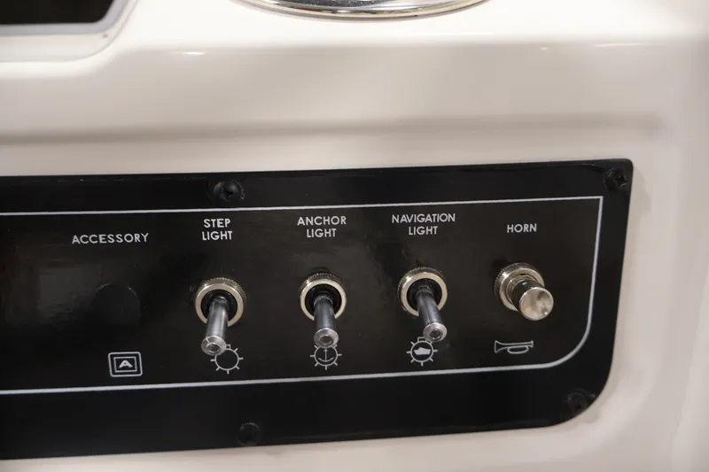 Slide: The Image of Control panel of 2026 Bayliner D22I boat with switches for lights and horn. - 22