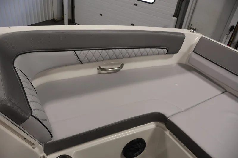Slide: The Image of Interior seating of 2026 Bayliner D22I boat with gray upholstery and diamond stitching. - 12
