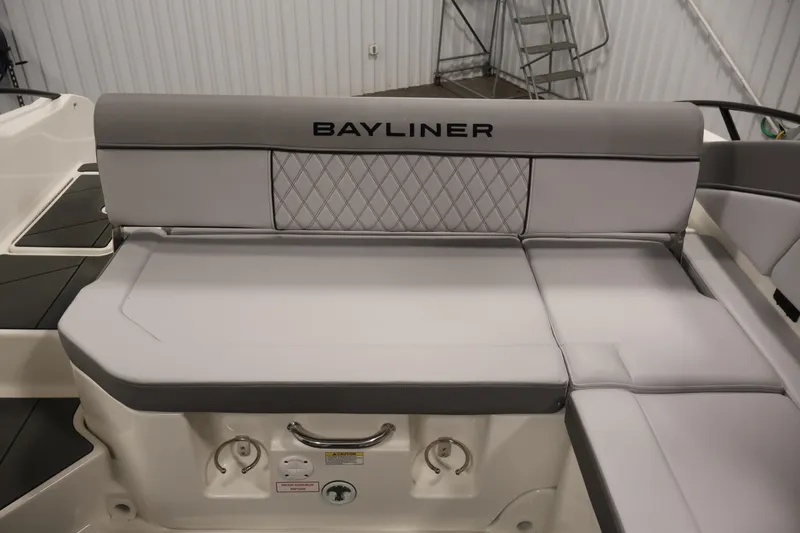 Slide: The Image of 2026 Bayliner D22I boat interior with gray cushioned seating and diamond pattern design. - 32