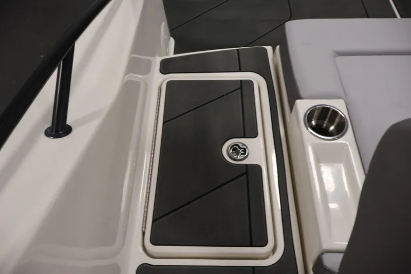 Slide: The Image of 2026 Bayliner D22I boat interior with storage compartment and cup holder. - 36