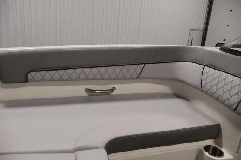 Slide: The Image of 2026 Bayliner D22I boat interior with gray and white cushioned seating. - 14