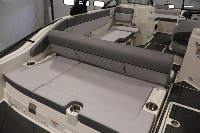 Slide: The Image of 2026 Bayliner D22I boat interior with gray seating and cup holders. - 38