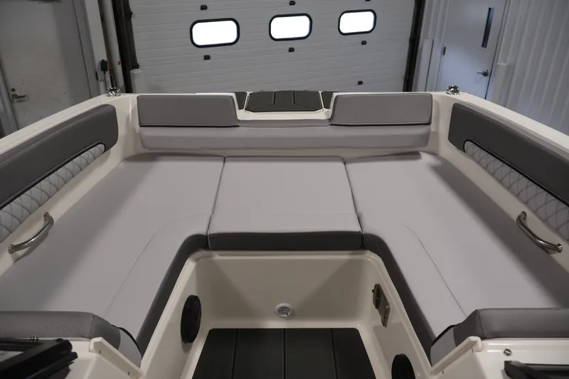 Slide: The Image of 2026 Bayliner D22I boat interior with gray cushioned seating and modern design. - 10