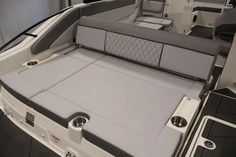 Slide: The Image of 2026 Bayliner D22I boat interior with cushioned seating and cup holders. - 39