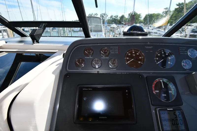 Slide: The Image of 1998 Tiara Yachts 3100 Open dashboard with gauges and Garmin GPS display. - 10