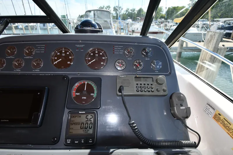 Slide: The Image of Dashboard of a 1998 Tiara Yachts 3100 Open with gauges and navigation equipment. - 11
