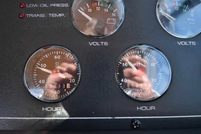 Slide: The Image of Instrument panel of a 1998 Tiara Yachts 3100 Open, displaying volt and hour gauges. - 12