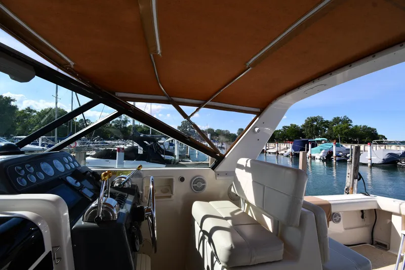 Slide: The Image of 1998 Tiara Yachts 3100 Open interior with helm, docked at marina. - 13