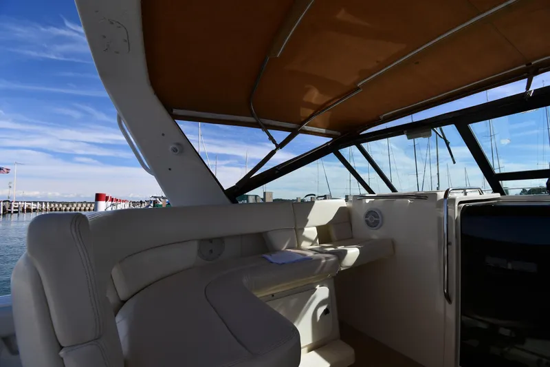 Slide: The Image of 1998 Tiara Yachts 3100 Open interior with seating, docked at marina under blue sky. - 14