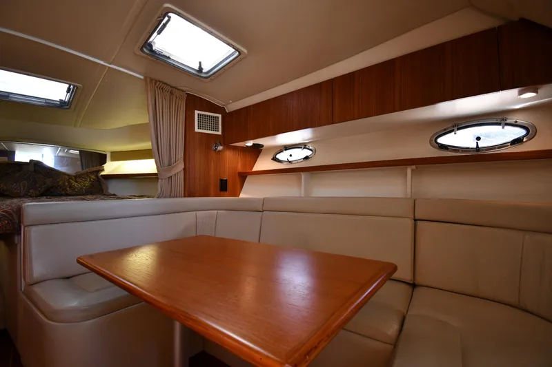 Slide: The Image of 1998 Tiara Yachts 3100 Open cabin interior with seating and table. - 23