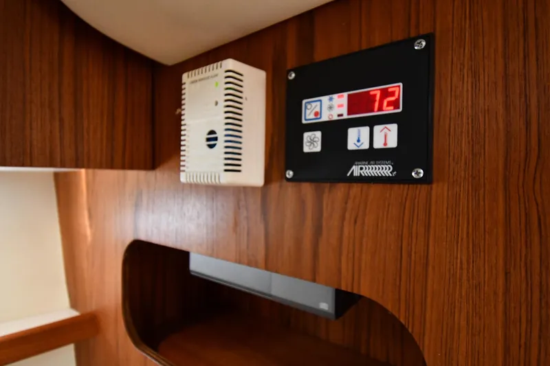 Slide: The Image of Control panel and vent on 1998 Tiara Yachts 3100 Open's wooden interior. - 34