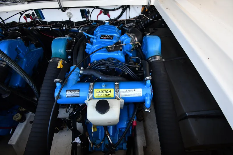 Slide: The Image of Engine compartment of a 1998 Tiara Yachts 3100 Open, featuring a blue engine. - 36