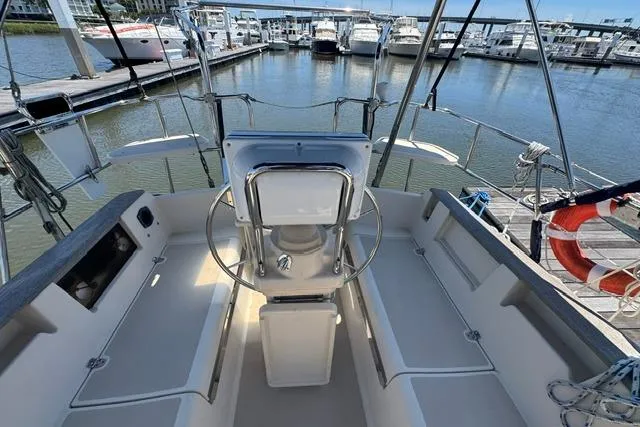 Slide: The Image of Cockpit view of a 1997 Island Packet 37 sailboat docked at a marina. - 10