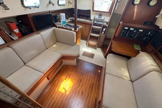Slide: The Image of Interior of 1997 Island Packet 37 sailboat with cozy seating and wooden flooring. - 19