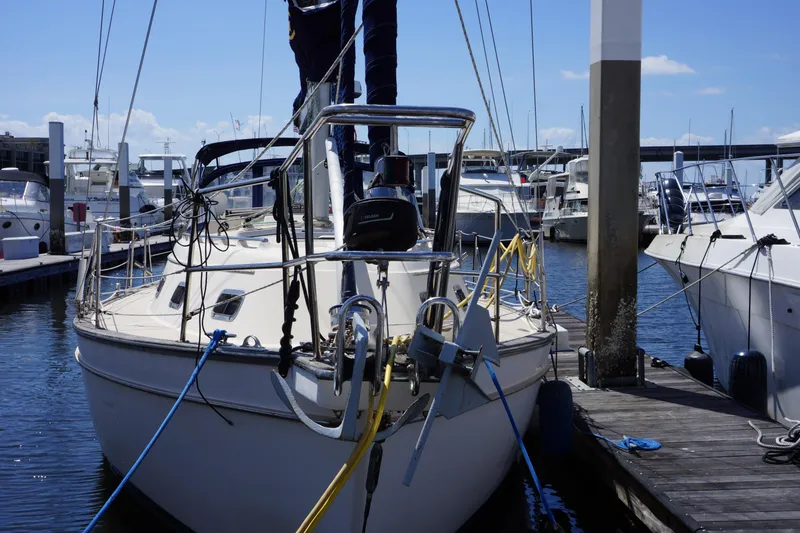 Slide: The Image of 1997 Island Packet 37 sailboat docked at marina, surrounded by other boats. - 2