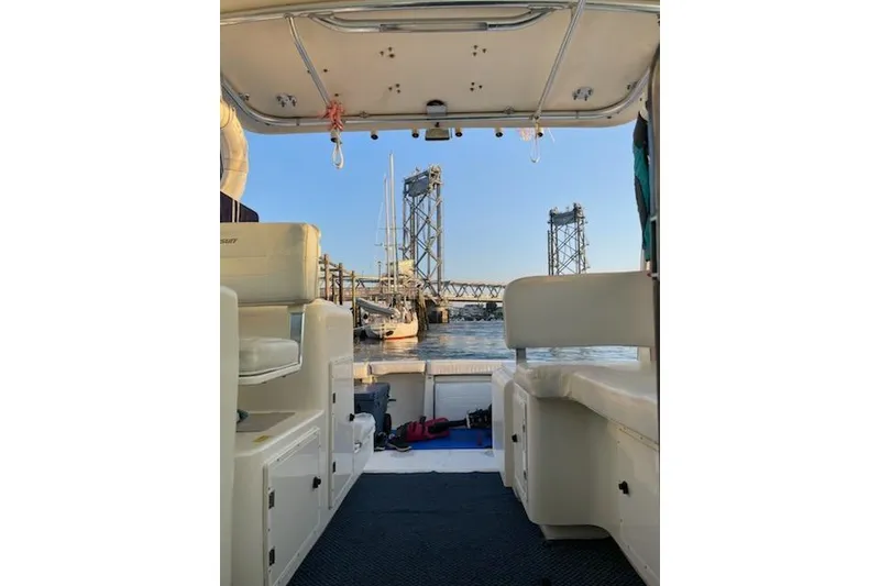 Slide: The Image of 2003 Pursuit 3000 Express boat interior with marina and bridge view. - 11