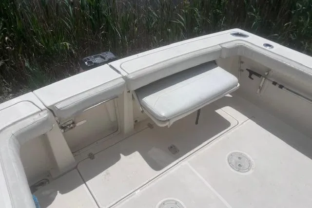 Slide: The Image of 2003 Pursuit 3000 Express boat interior with foldable seating and storage compartments. - 13