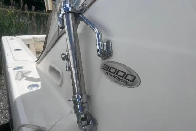 Slide: The Image of 2003 Pursuit 3000 Express boat detail with chrome fittings and model emblem. - 15