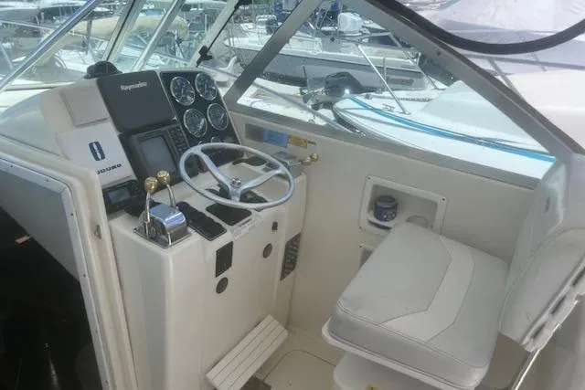 Slide: The Image of 2003 Pursuit 3000 Express boat cockpit with steering wheel and control panel. - 17