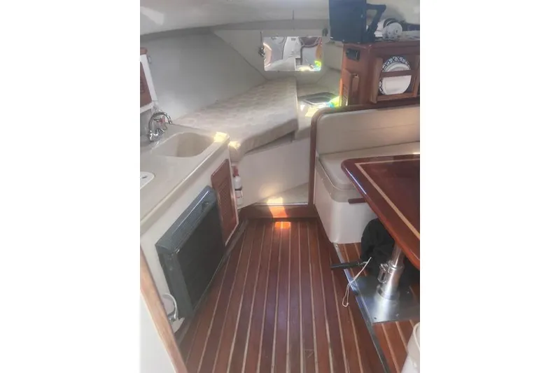 Slide: The Image of Interior of 2003 Pursuit 3000 Express boat with wood flooring and seating area. - 24