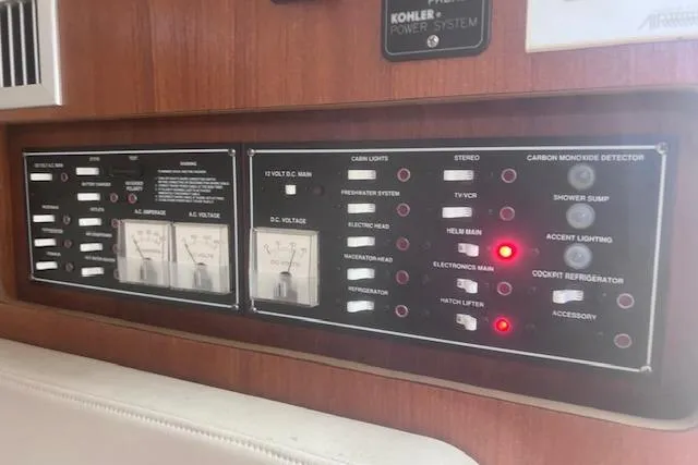 Slide: The Image of Control panel of a 2003 Pursuit 3000 Express boat with various switches and indicators. - 28