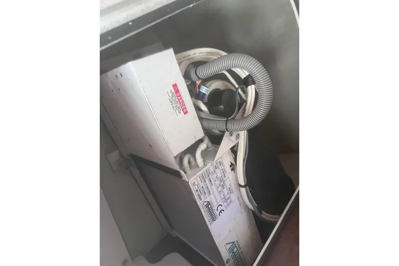 Slide: The Image of Electrical components inside a 2003 Pursuit 3000 Express boat compartment. - 32