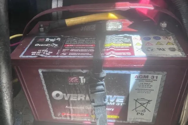 Slide: The Image of Battery compartment of a 2003 Pursuit 3000 Express with OverDrive AGM 31 battery. - 34