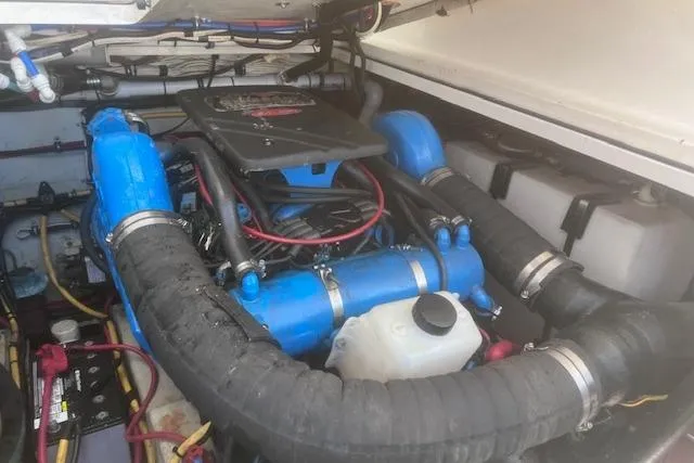 Slide: The Image of Engine compartment of a 2003 Pursuit 3000 Express boat with blue components and wiring. - 37