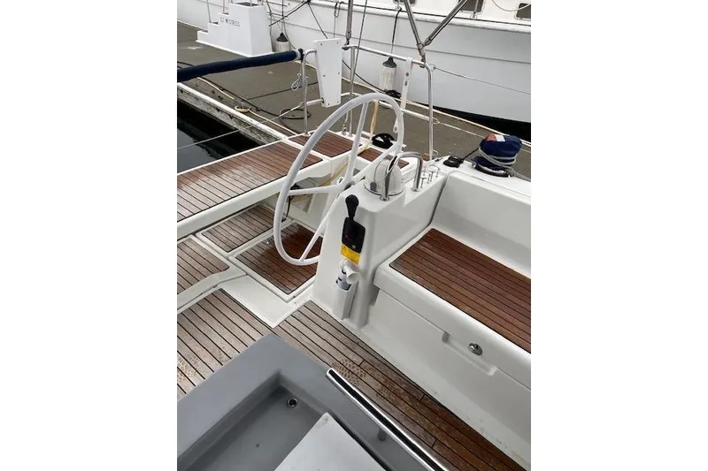 Slide: The Image of 2018 Beneteau Oceanis 45 yacht cockpit with wooden deck and steering wheel. - 20