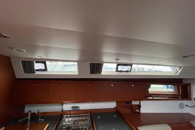 Slide: The Image of Interior of 2018 Beneteau Oceanis 45 yacht, featuring a modern kitchen area. - 31