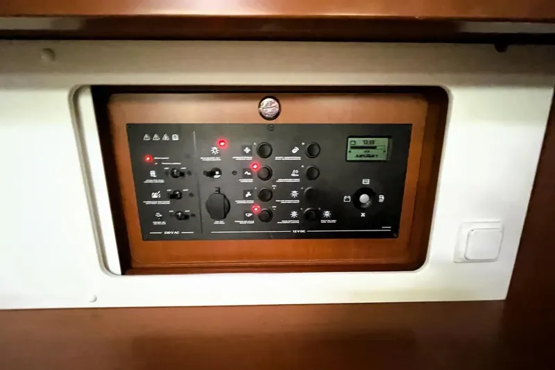 Slide: The Image of Control panel of a 2018 Beneteau Oceanis 45 yacht, featuring various switches and indicators. - 37