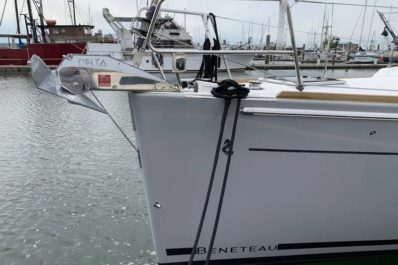 Slide: The Image of Beneteau Oceanis 45 sailboat, 2018 model, docked with visible anchor and marina background. - 7