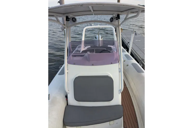 Slide: The Image of 2016 Brig E780 boat with console and seating, docked by the water. - 15